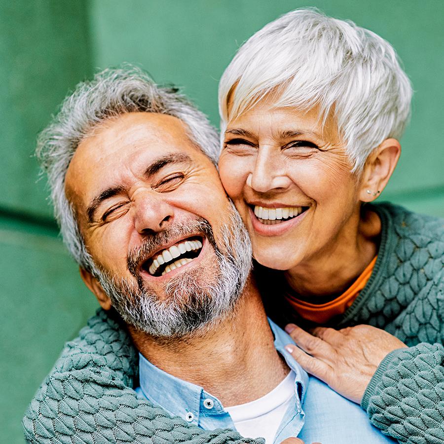 older couple in La Mesa, CA smiling with crowns and bridges